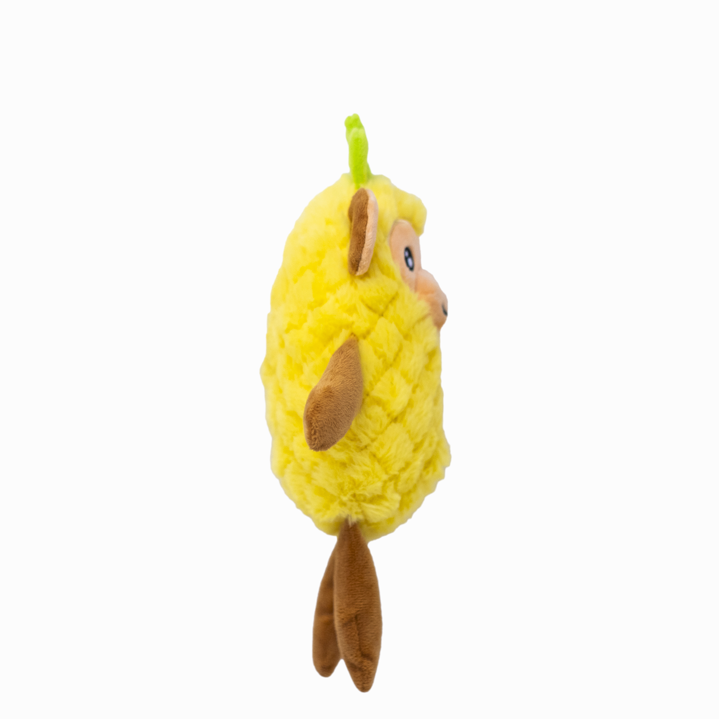 The side view of a plush yellow dog toy resembling a monkey in a pineapple costume on a white background