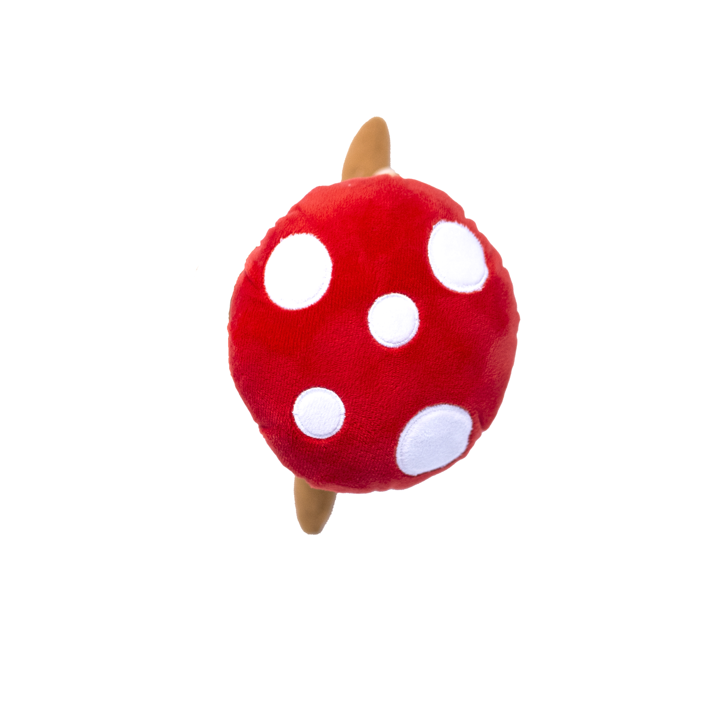 The top view of a plush red, white and brown dog toy resembling a monkey in a mushroom costume on a white background