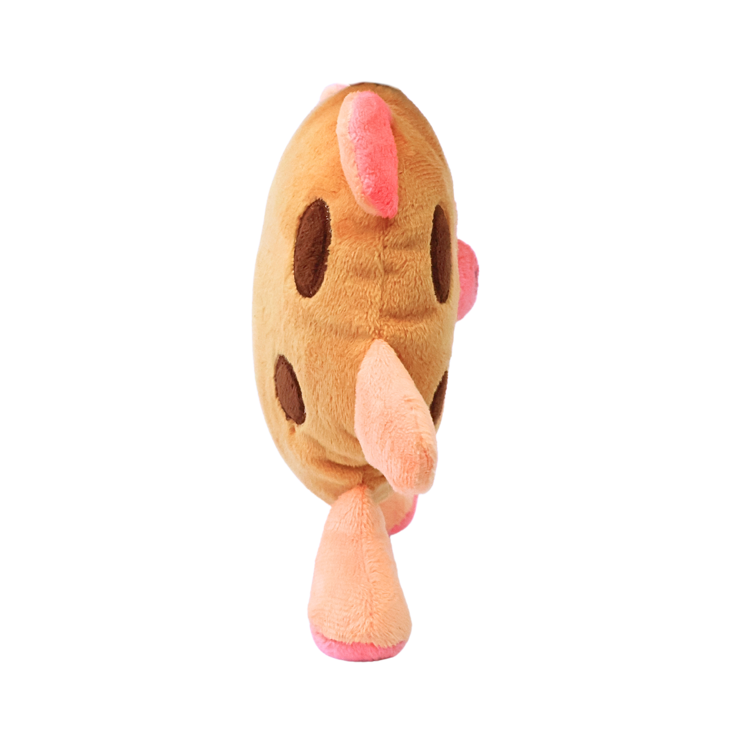 The side view of a plush brown and pink dog toy resembling a pig in a chocolate chip cookie costume