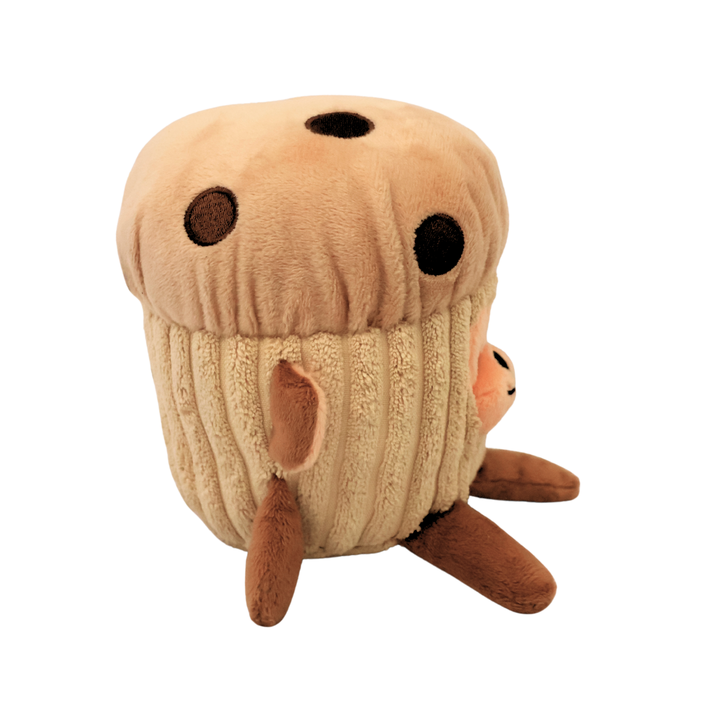 The side view of a plush brown dog toy resembling a monkey in a chocolate chip muffin costume on a white background